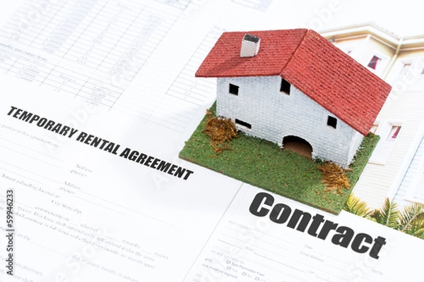 Fototapeta Small wooden house on contract forms.