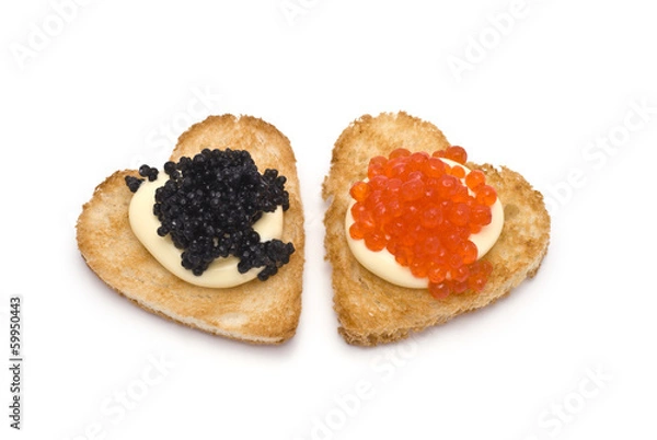 Fototapeta Two Heart-Shaped Toasts with Red and Black Caviar on White Sauce