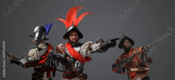 Fototapeta Portrait of conquistadors with steel armor and plumed helemt holding flintlock guns.