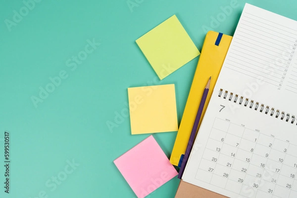 Fototapeta close up of calendar on the colorful table background, planning for business meeting or travel planning concept