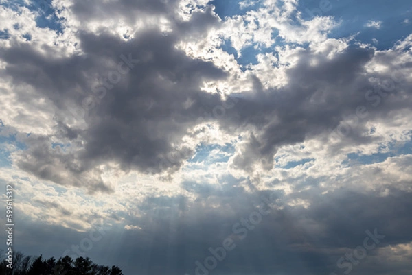 Obraz Looking up at gray clouds with silver lining against blue sky