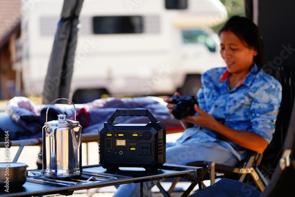 Fototapeta Power station, camping equipment. Lithium ion battery charger for outdoor activity and emergency. Soft and selective focus on main object.
