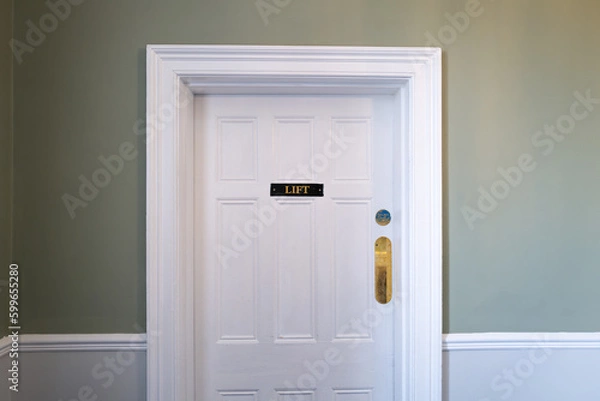 Fototapeta Entrance to an internal lift seen within a once stately home now a luxury hotel.