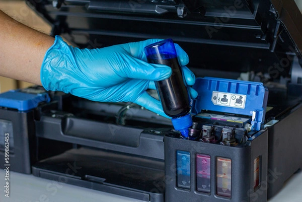 Fototapeta Technicians Refill ink cartridges, printer Inkjet colors.Printer Repairs and Maintenance inkjet or Laser printers concept ,selective focus