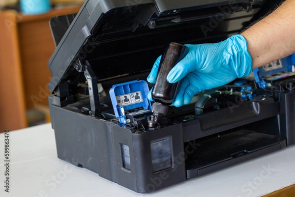 Fototapeta Technicians Refill ink cartridges, printer Inkjet colors.Printer Repairs and Maintenance inkjet or Laser printers concept ,selective focus