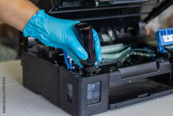 Fototapeta Technicians Refill ink cartridges, printer Inkjet colors.Printer Repairs and Maintenance inkjet or Laser printers concept ,selective focus