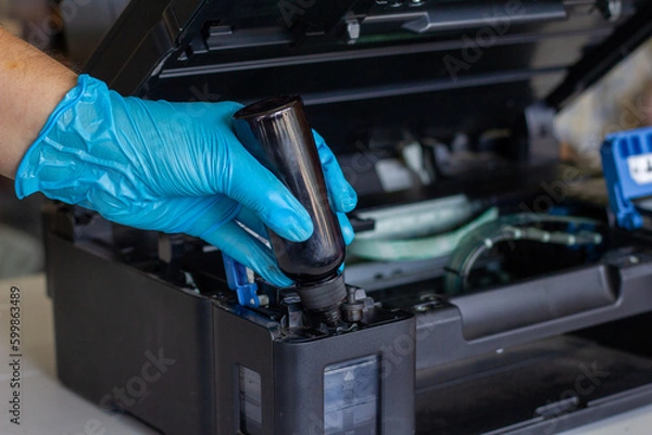 Fototapeta Technicians Refill ink cartridges, printer Inkjet colors.Printer Repairs and Maintenance inkjet or Laser printers concept ,selective focus