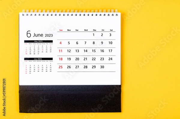 Fototapeta The June 2023 Monthly desk calendar for 2023 year on yellow background.