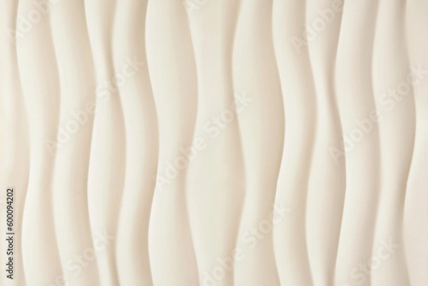 Fototapeta beige or ivory textured background with vertical waves, sandy smooth curved lines background.