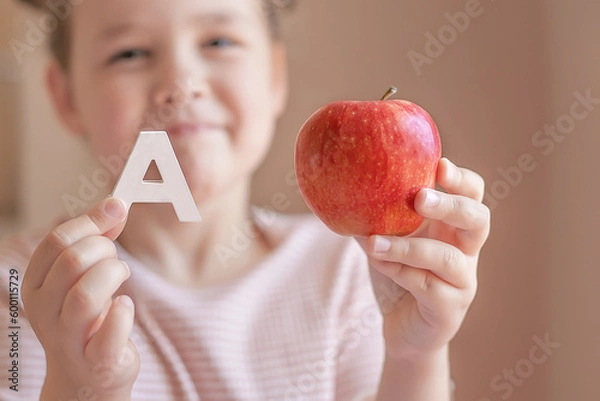 Obraz Kids learn to read. Colorful abc for kindergarten and preschool children. Remote learning and homeschooling for young kid. Child reading sounds and letters. English lesson. Selective focus