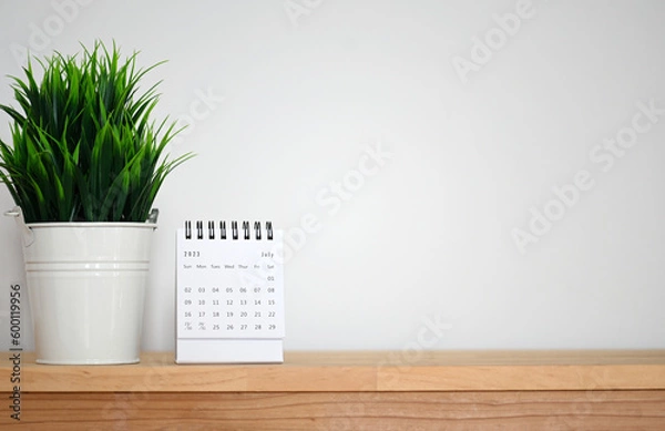 Fototapeta July Calendar 2023 on table background.Time planning, day counting and holidays