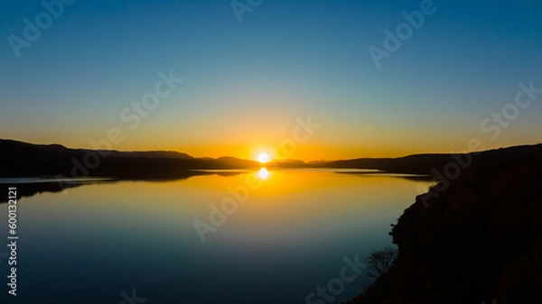 Fototapeta sunset over the lake. The setting sun over the lake as the evening sun sets. wonderful sky