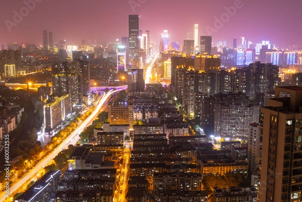 Fototapeta night view of modern complex and traffic along on busy road from daytime to evening photo at high-rise building near junction of Liuyang and Xiangjiang rivers, Changsha, China