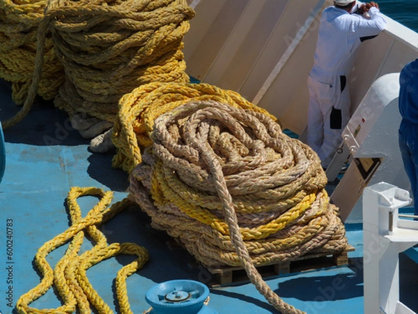 Fototapeta Ropes coiled on deck of a ship waiting to be used