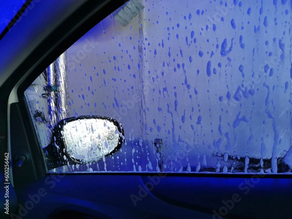 Fototapeta Car Care Business. Automatic Car Wash Process. Spray foam bubble shampoo on the car surface. Inside view, copy space