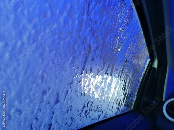 Fototapeta Car Care Business. Automatic Car Wash Process. Spray foam bubble shampoo on the car surface. Inside view, copy space