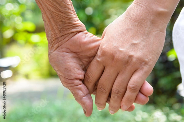 Obraz Senior and young holding hands