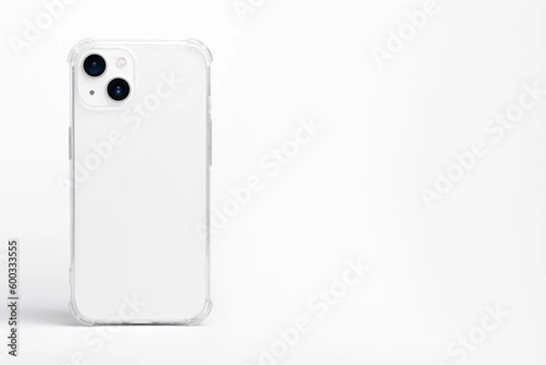 Obraz white iPhone 14 Plus and 13 mini in clear transparent soft silicone case back view. Phone case mockup isolated on grey background. Banner with place for text on the right