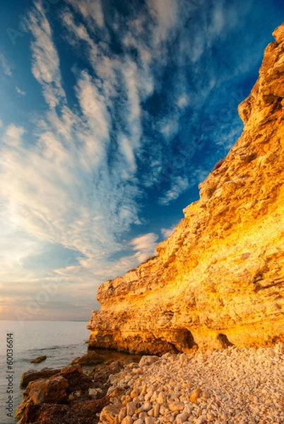 Fototapeta Coastal cliffs and the beach at sunset