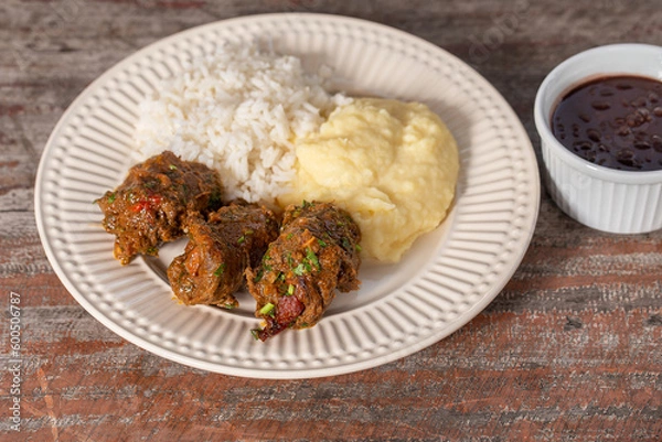 Fototapeta Beef rolls in delicious tomato sauce , served with rice and mashed potatoes. . Brazilian "bife a rolê"