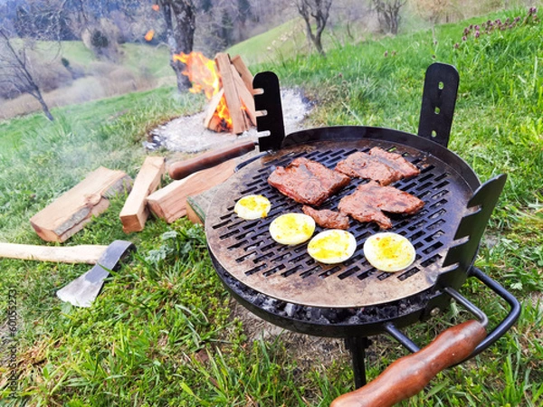 Obraz Beef steak on the grill with smoke and flames