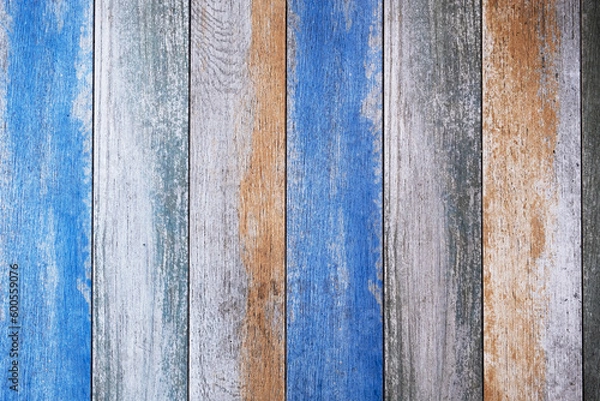 Fototapeta wooden board with bright blue and beige paint and cracks. vertical lines. rough surface texture