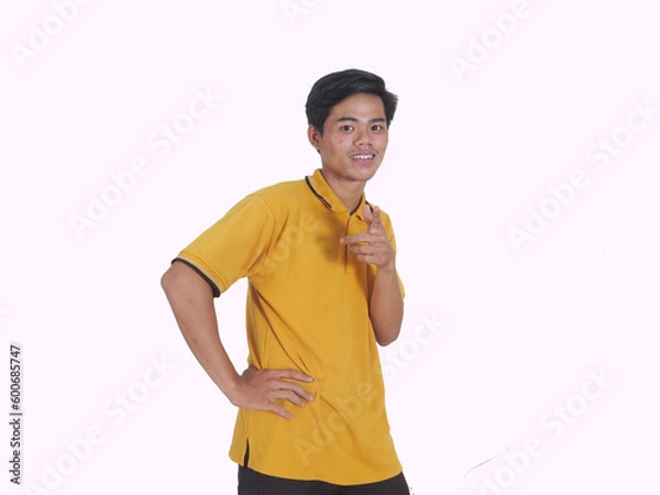 Fototapeta Side view of Adult Asian man smiling happy while pointing finger forward
