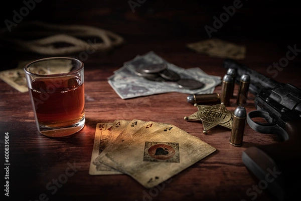 Fototapeta Poker at the Old Western Saloon Table with playing cards, whiskey and weapons