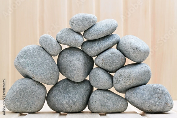 Obraz Sauna stones. Stacked on a wooden surface. Ready for heating.