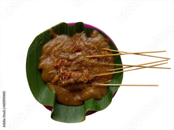 Obraz Satay Padang or called Sate Padang is Spicy chicken satay from Padang, West Sumatra. Served with spicy curry sauce and rice cake, served on plate plastic with banana leaf. Top view on transparent back