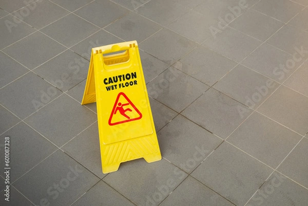Fototapeta Yellow Caution Slippery Wet Floor Sign Showing and Warning of Caution Wet Floor on the Walk Way