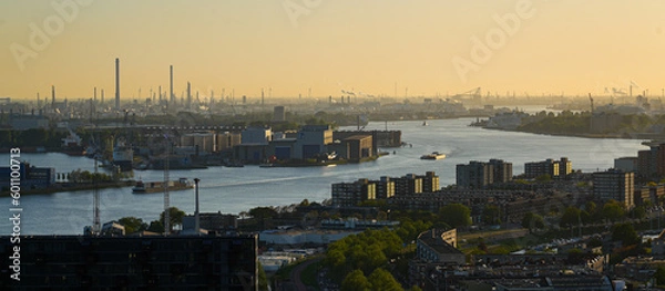 Obraz Aerial view of the New Meuse river at sunset, west of Rotterdam in the Netherlands - Large number of smokestacks in Europoort, the harbour of La Haye in the North Sea