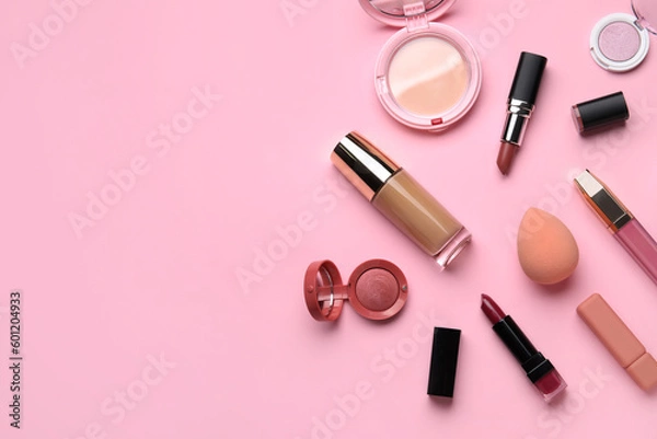 Fototapeta Decorative cosmetics with lipsticks and sponge on pink background