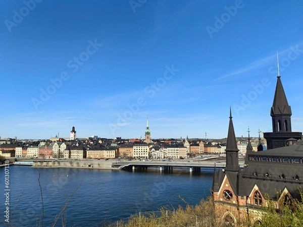 Obraz Panoramic view of Gamla Stan - the old town of Stockholm against the backdrop of water and blue sky.