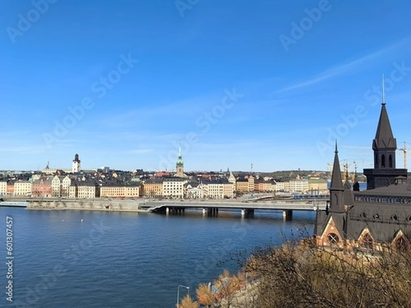 Obraz Panoramic view of Gamla Stan - the old town of Stockholm against the backdrop of water and blue sky.
