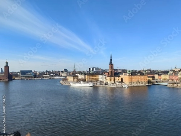Obraz Panoramic view of Gamla Stan - the old town of Stockholm against the backdrop of water and blue sky.