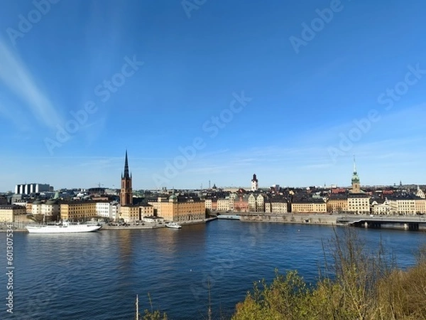 Obraz Panoramic view of Gamla Stan - the old town of Stockholm against the backdrop of water and blue sky.