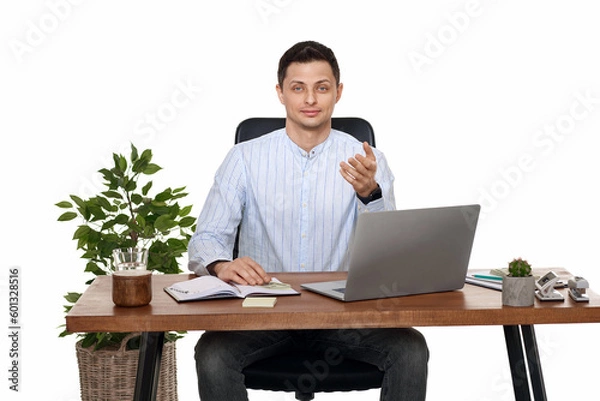 Fototapeta young man using laptop computer for online work at table