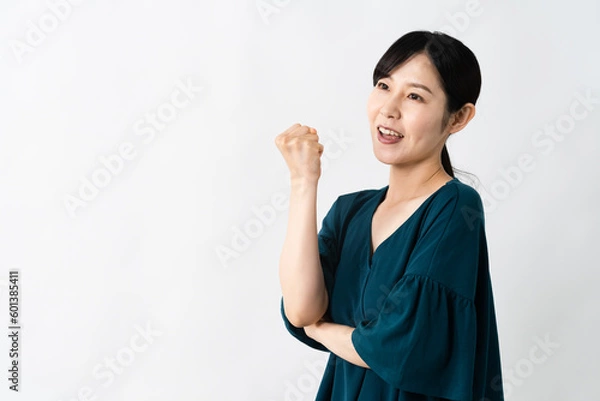 Fototapeta ガッツポーズをする若い女性　ライフスタイルイメージ