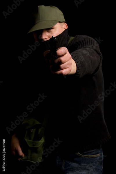 Fototapeta Disguised gunman pointing handgun in your face