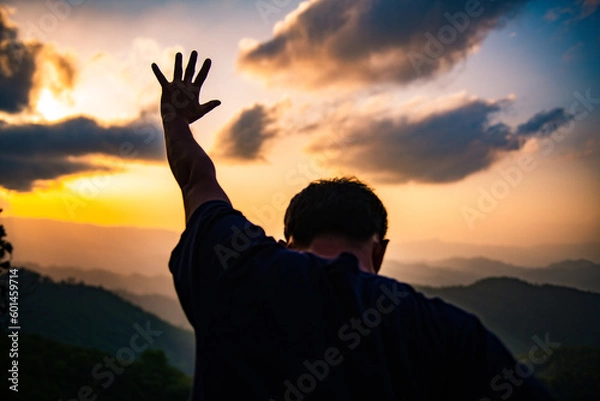 Fototapeta The human hand raises his palm open to worship. Eucharist, bless the Lord, help Catholics repent of Easter. behind the concept of Christianity Battle and Victory for God