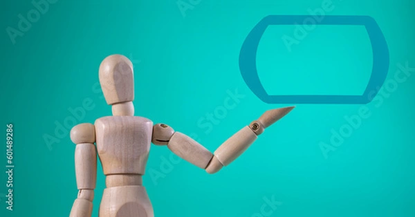 Fototapeta Wooden Figure Sitting. Hand Shows Open Palm with Copy Space Product or Text. Standing Wooden Man.