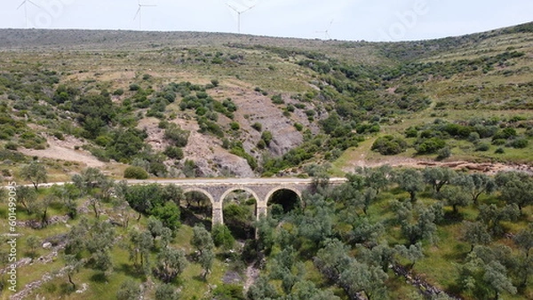 Obraz Tatar Bridge - Very old stone arch bridge from Ottoman or even older times about 30 m long with three arches, 2 central piers, completely preserved near Urla, Turkish Aegean Sea