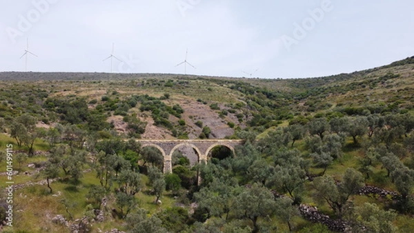Obraz Tatar Bridge - Very old stone arch bridge from Ottoman or even older times about 30 m long with three arches, 2 central piers, completely preserved near Urla, Turkish Aegean Sea