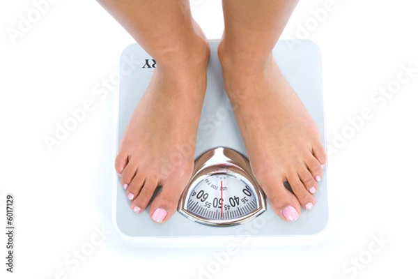 Fototapeta Woman legs with  scales on  isolated background