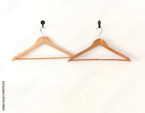 Obraz Two old wooden coat hangers on a white wall