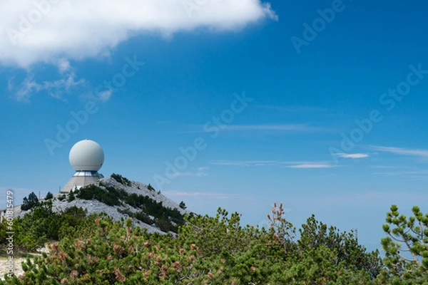 Obraz The top of the Mont Ventoux in Vaucluse,  with the Radôme, a civil aviation radar. Pines tree in the foreground. A blue sky.