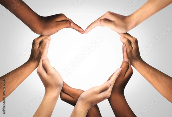 Fototapeta Unity and diversity are at the heart of a diverse group of people connected together as a supportive symbol that represents a sense of and togetherness. Symbol and shape created from hands.