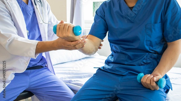 Fototapeta Professional therapist stretching Patients with muscular disease, rehabilitation and treatment of physiological disorders according to the concept of a physiotherapist.