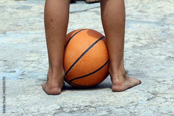 Fototapeta a basketball put in both feet